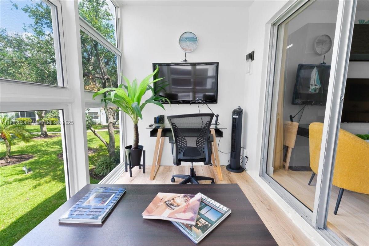 1501 South Ocean Boulevard, Unit 227 Lauderdale-by-the-Sea, FL 33062 - Photo 8 of 23 a living room with furniture and a floor to ceiling window