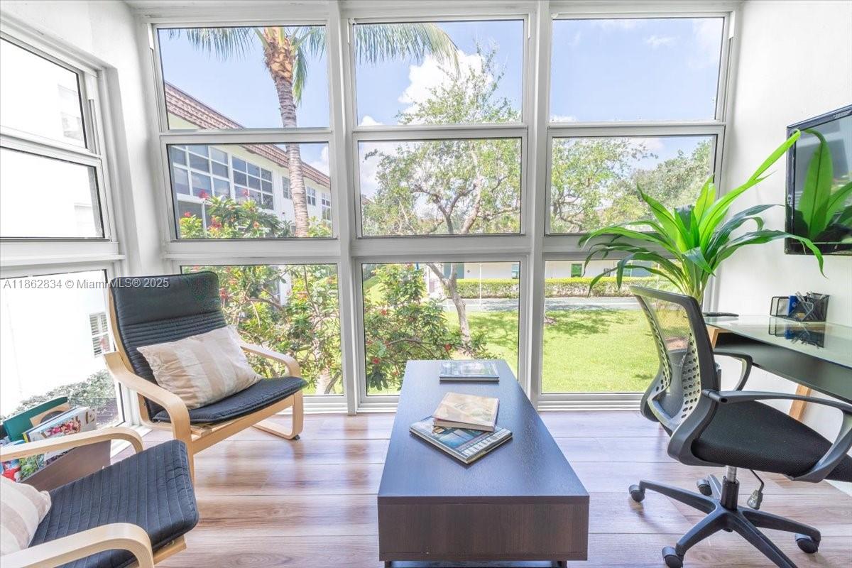 1501 South Ocean Boulevard, Unit 227 Lauderdale-by-the-Sea, FL 33062 - Photo 9 of 23 a living room with furniture and floor to ceiling windows