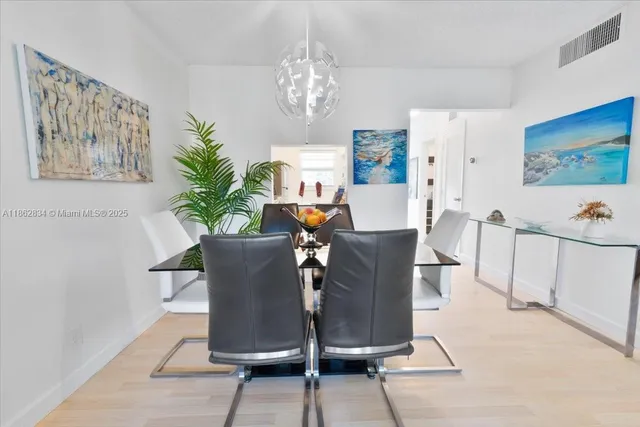 a living room with furniture a chandelier and a table