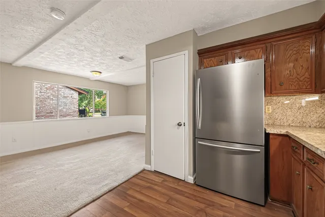 a kitchen with stainless steel appliances granite countertop a stove and cabinets