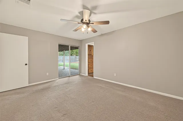 a view of an empty room with a fan