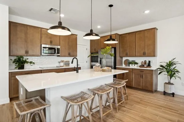 a kitchen with a table a sink and cabinets