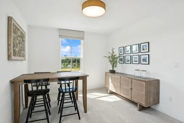 a dining room with furniture and window
