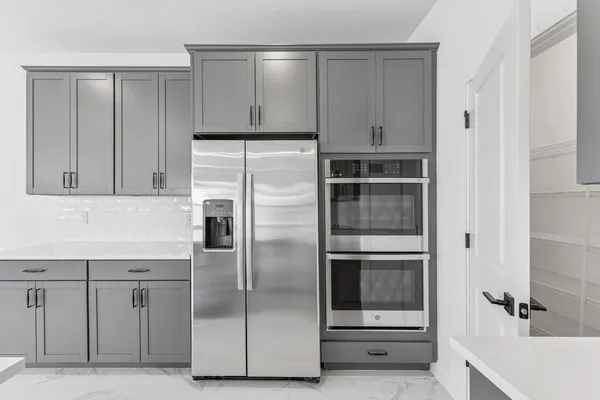 a kitchen with cabinets and stainless steel appliances