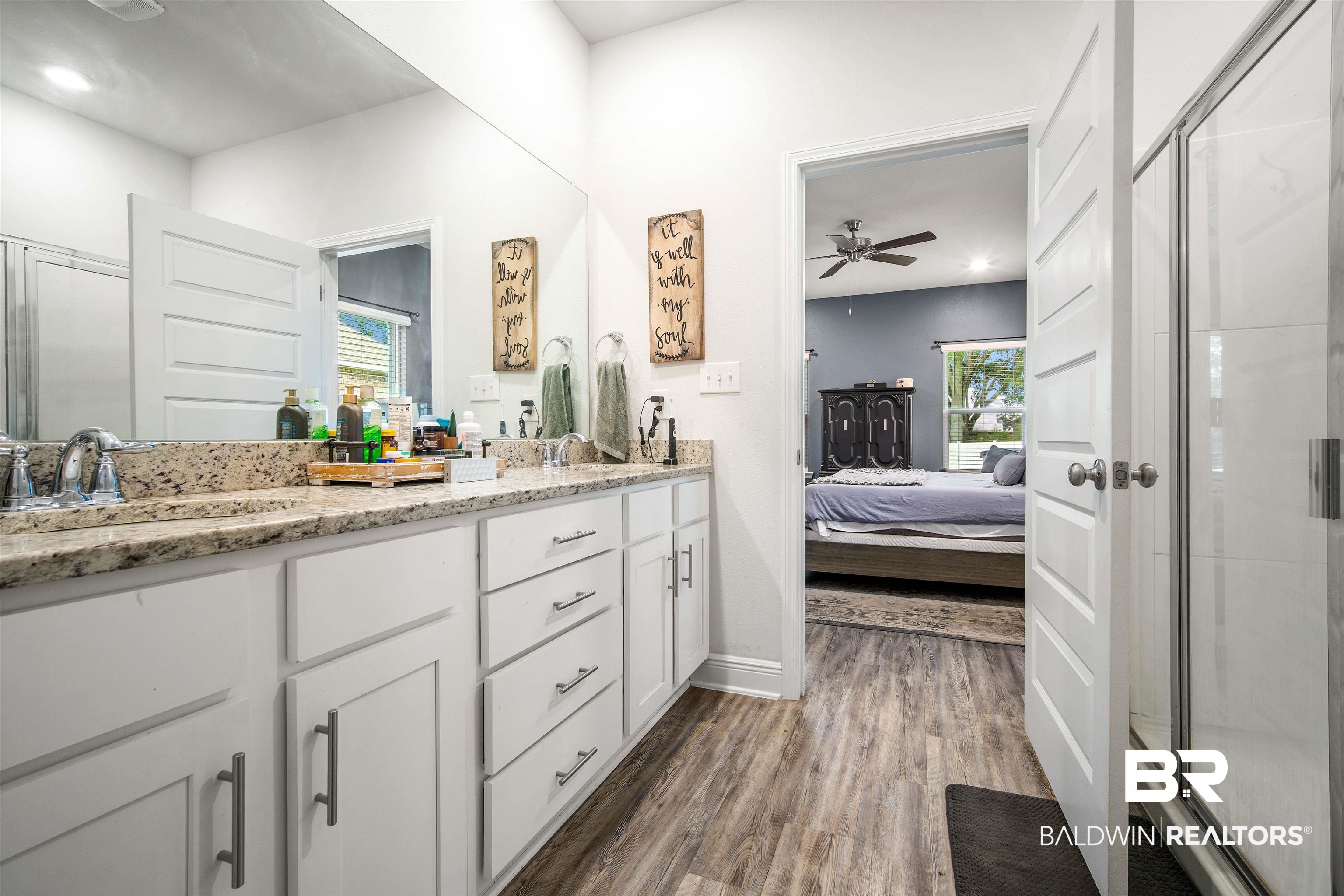 24341 Alydar Loop Daphne, AL 36526 - Photo 19 of 45 Ensuite bathroom featuring wood finished floors, a shower stall, double vanity, ceiling fan, and baseboards