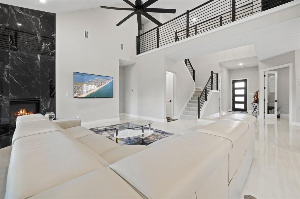 1008 Willie Rnch Way Leander, TX 78641 - Photo 14 of 40 Living area with ceiling fan, a premium fireplace, recessed lighting, and a high ceiling