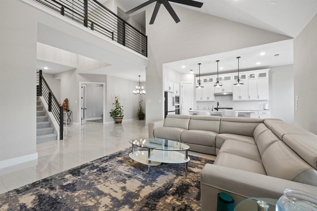 1008 Willie Rnch Way Leander, TX 78641 - Photo 18 of 40 Living area with a ceiling fan, a high ceiling, and hanging lights