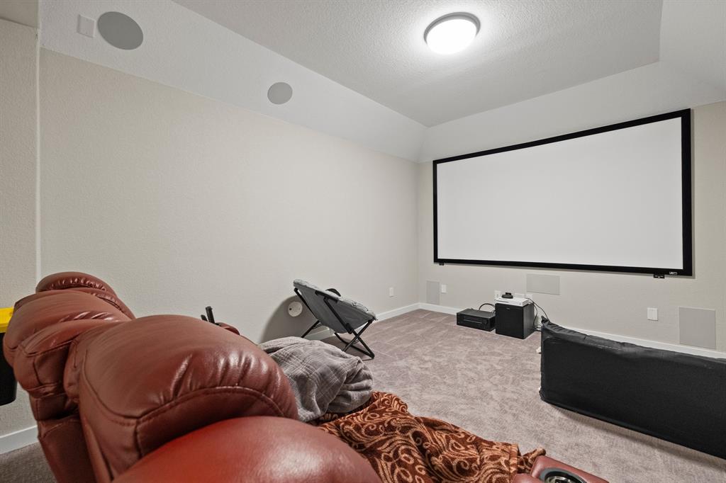 1008 Willie Rnch Way Leander, TX 78641 - Photo 26 of 40 Carpeted cinema room with a textured ceiling and baseboards