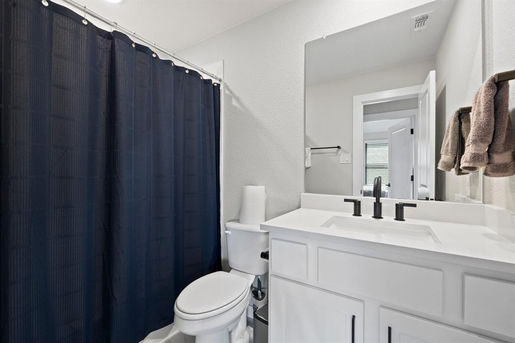 1008 Willie Rnch Way Leander, TX 78641 - Photo 27 of 40 Full bathroom with a textured wall, vanity, and a shower with curtain