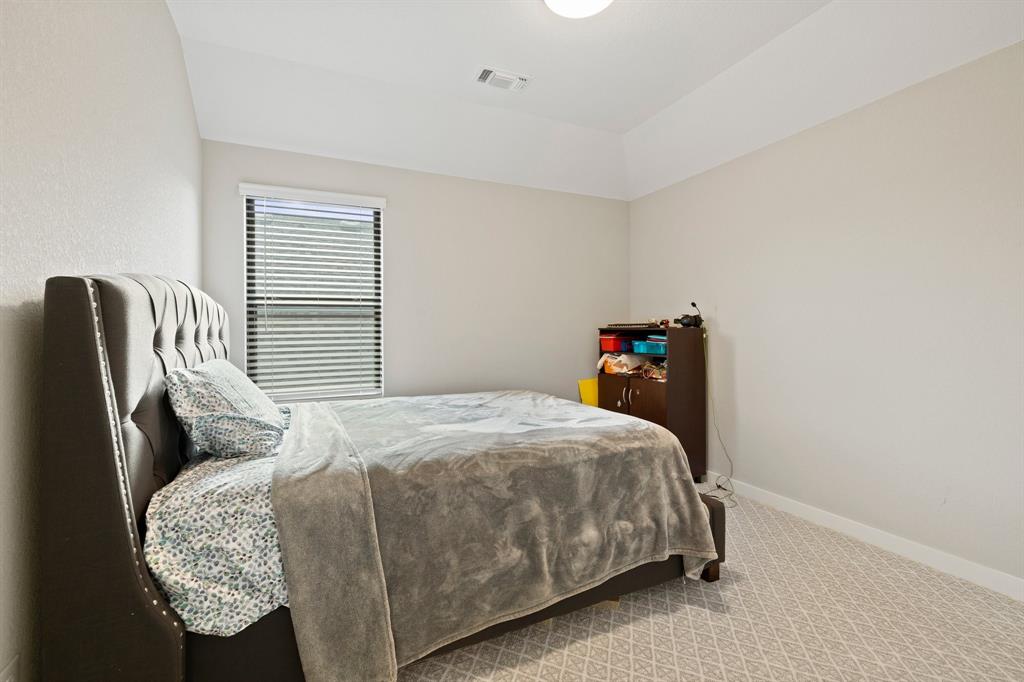 1008 Willie Rnch Way Leander, TX 78641 - Photo 28 of 40 Bedroom featuring light carpet and vaulted ceiling