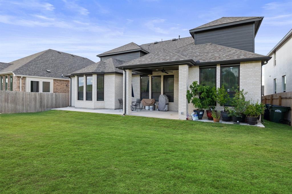 1008 Willie Rnch Way Leander, TX 78641 - Photo 31 of 40 Rear view of house featuring a fenced backyard, a patio area, a ceiling fan, brick siding, and a shingled roof