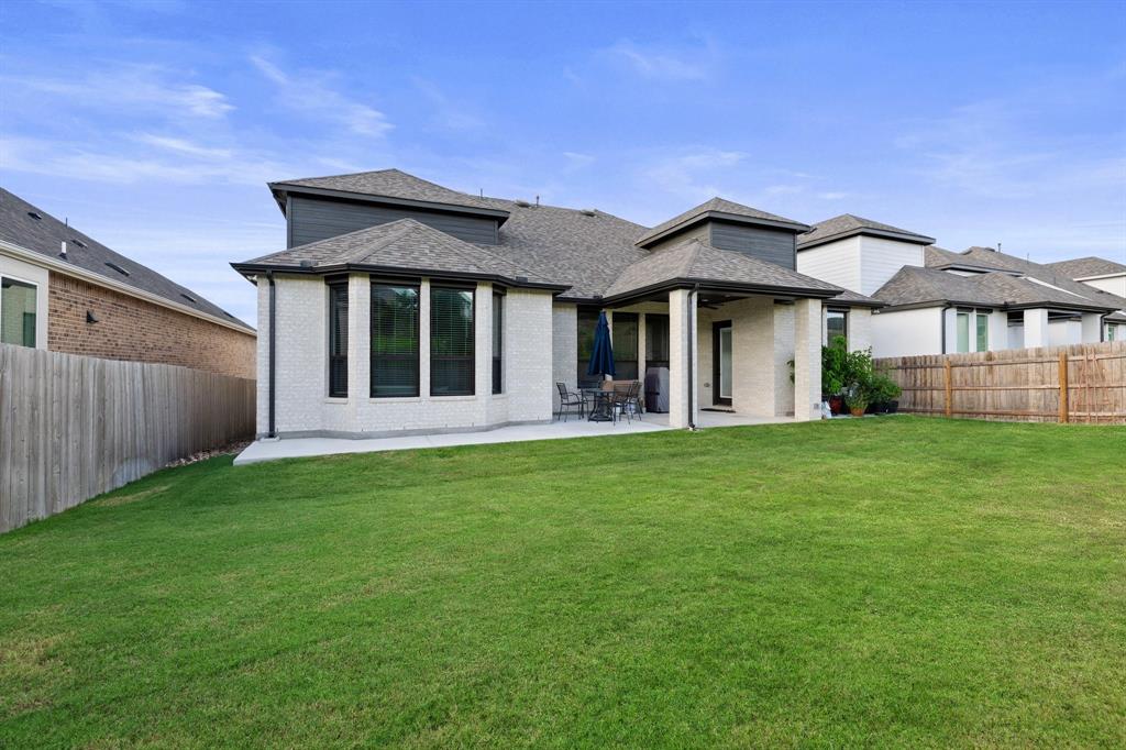 1008 Willie Rnch Way Leander, TX 78641 - Photo 32 of 40 Back of house with a patio, a fenced backyard, brick siding, and a shingled roof