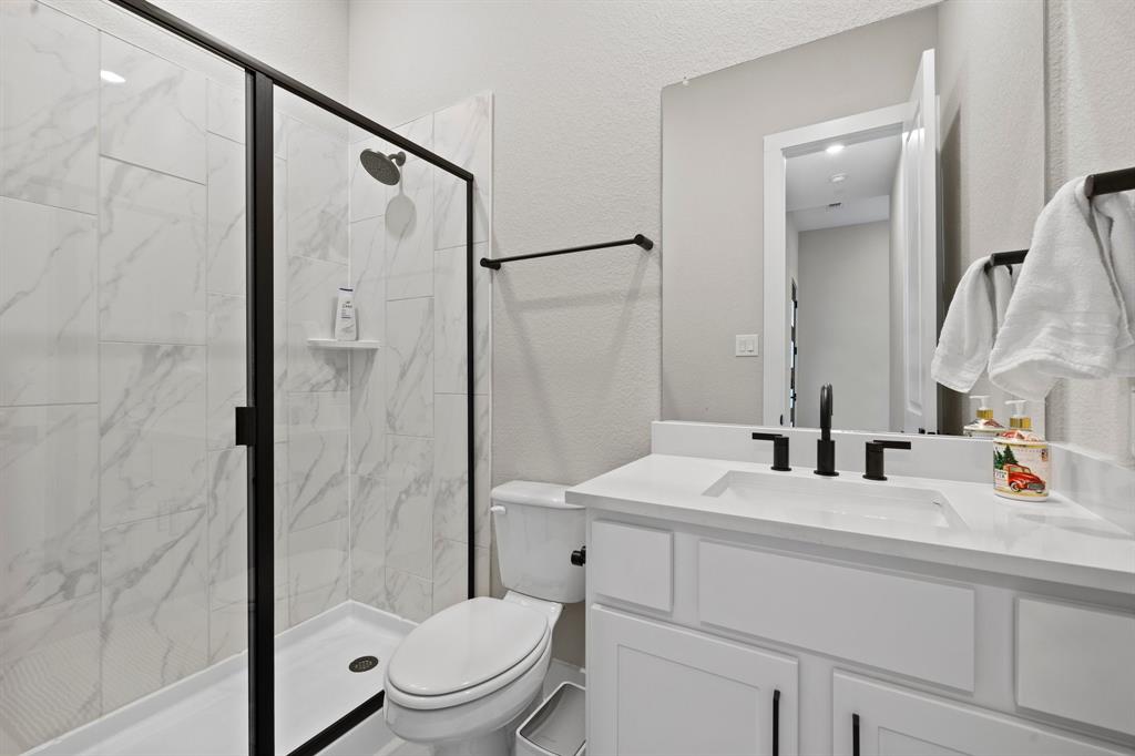 1008 Willie Rnch Way Leander, TX 78641 - Photo 9 of 40 Full bath with a textured wall, vanity, and a marble finish shower