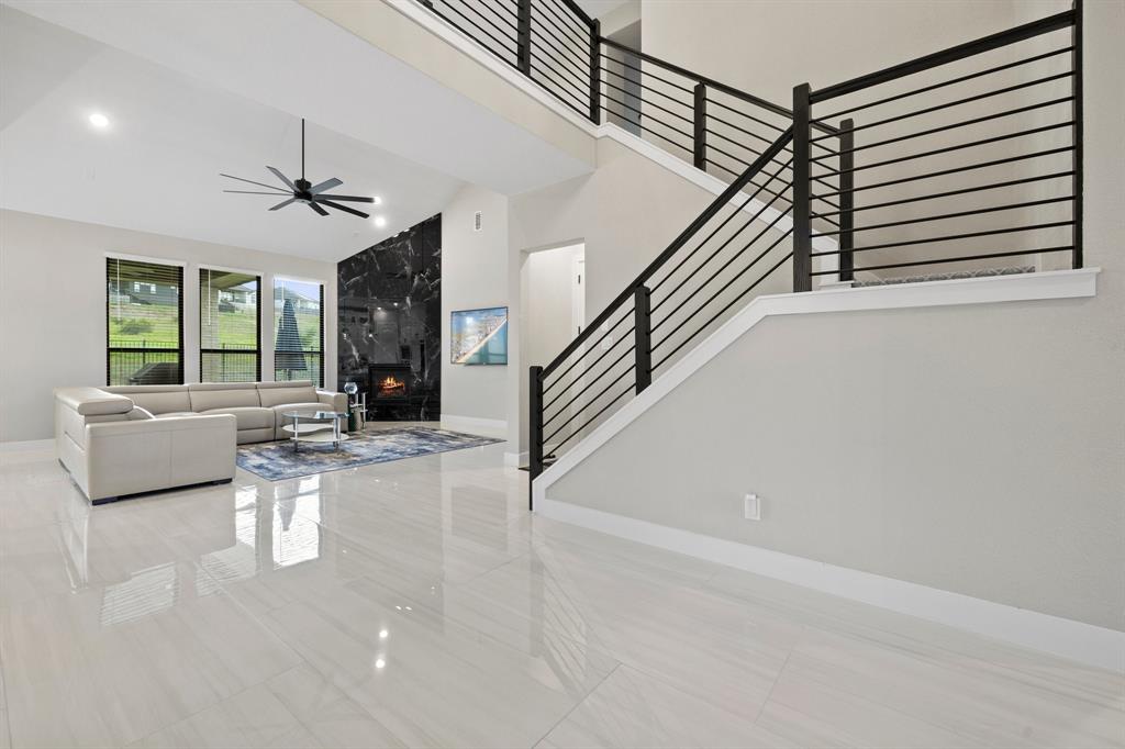 1008 Willie Rnch Way Leander, TX 78641 - Photo 10 of 40 Living room with a ceiling fan and a high ceiling