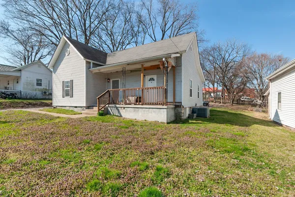a house view with swimming pool in front of it
