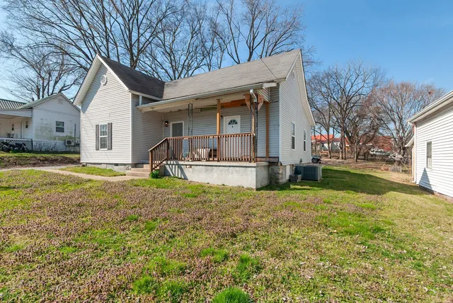 a house view with swimming pool in front of it