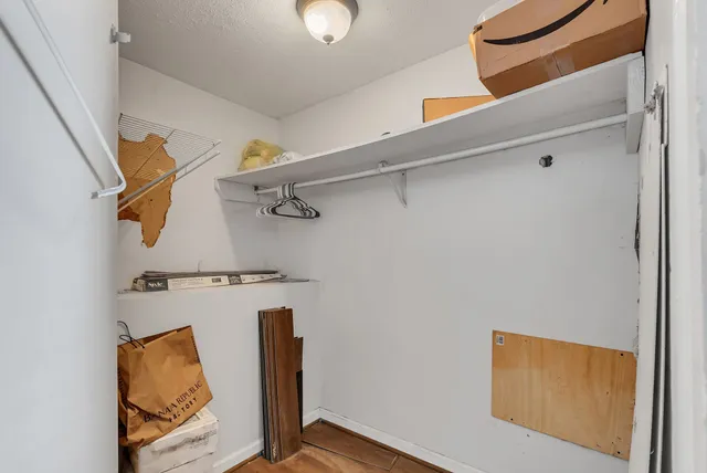 a view of a room with wooden floor and windows