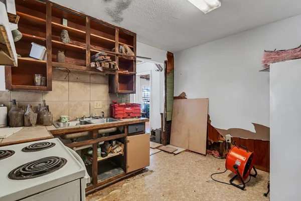 a kitchen with a stove and a white cabinets