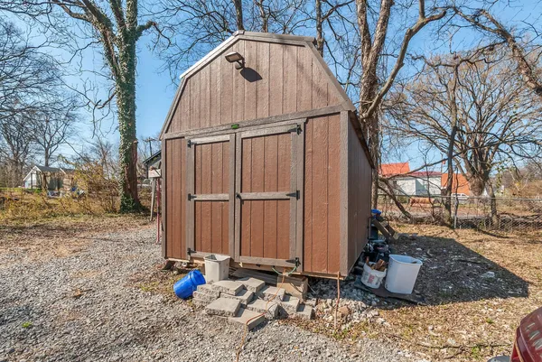 a view of a house with a yard covered in the road