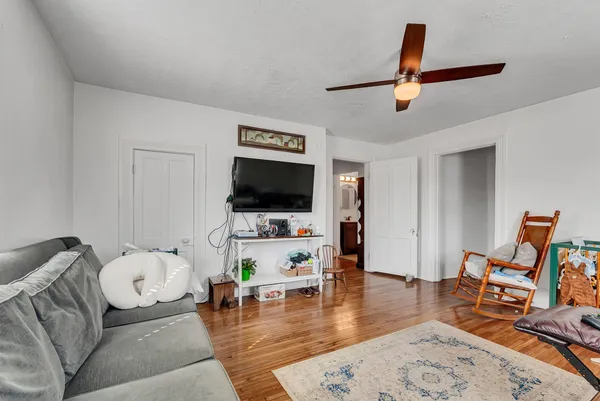 a view of a room with wooden floor and furniture