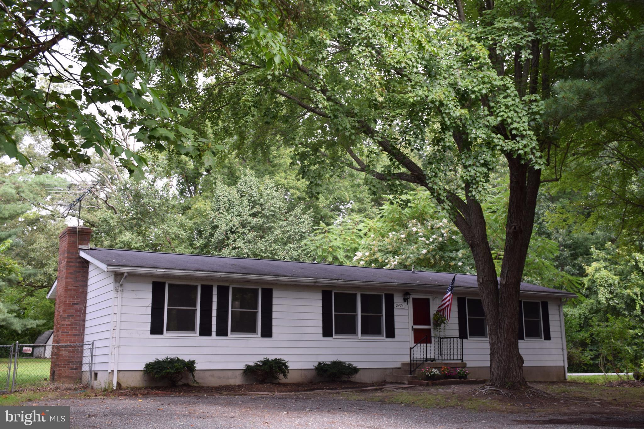 2471 Hallowing Point Road Prince Frederick, MD 20678 - Photo 1 of 30 a front view of a house with a garden