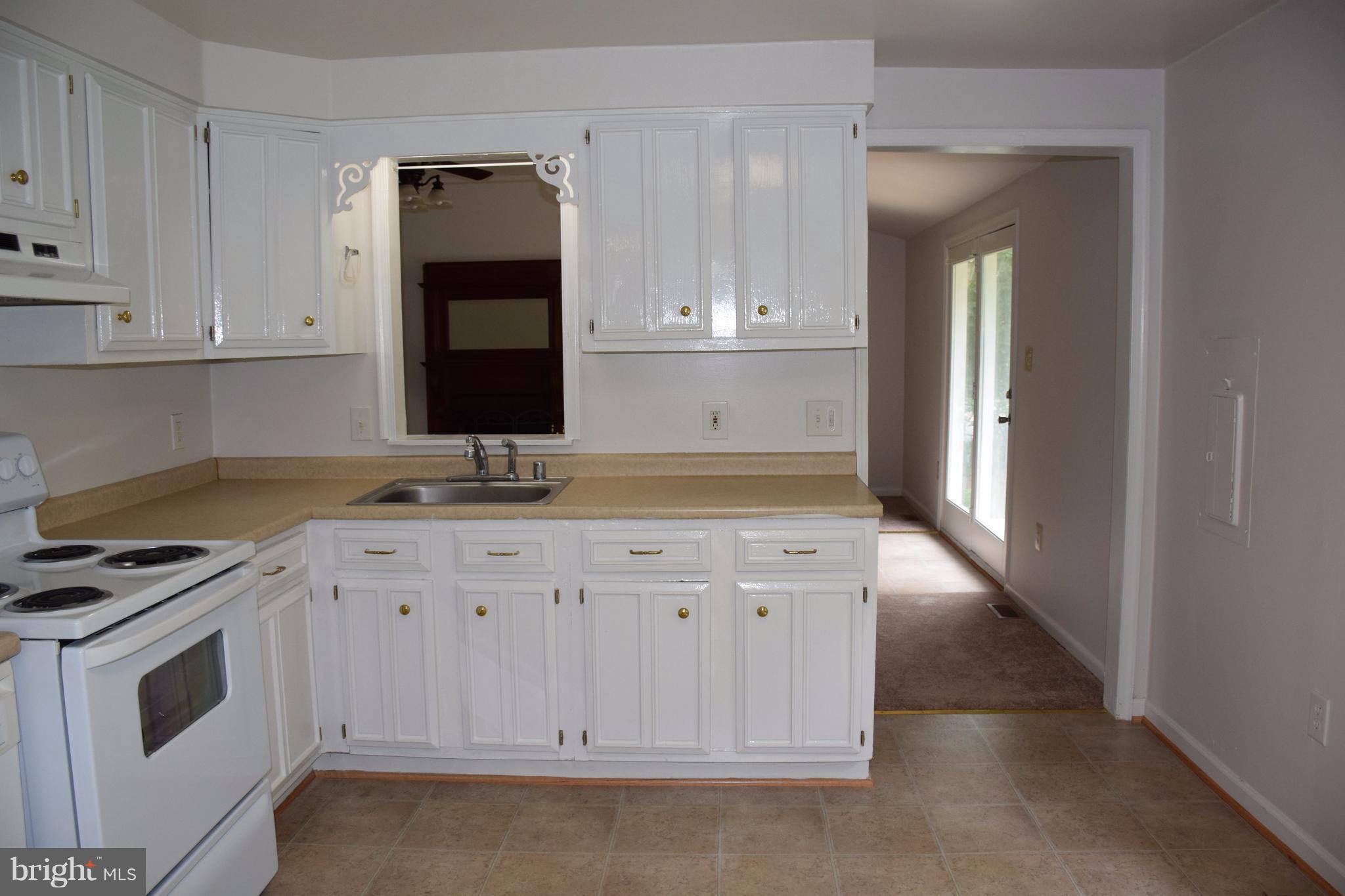 2471 Hallowing Point Road Prince Frederick, MD 20678 - Photo 11 of 30 a kitchen with granite countertop a sink a stove and cabinets