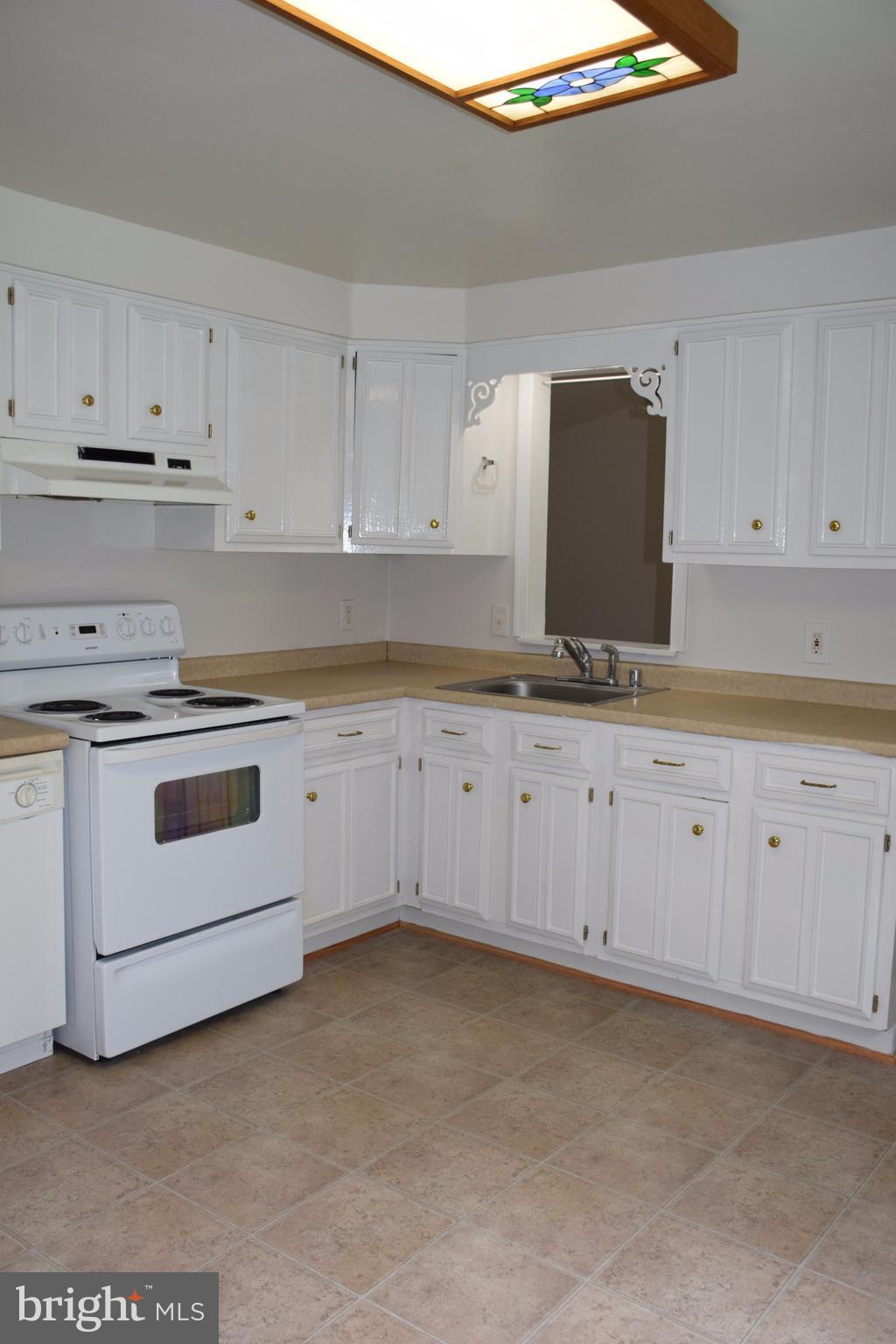 2471 Hallowing Point Road Prince Frederick, MD 20678 - Photo 13 of 30 a kitchen with granite countertop white cabinets and white appliances
