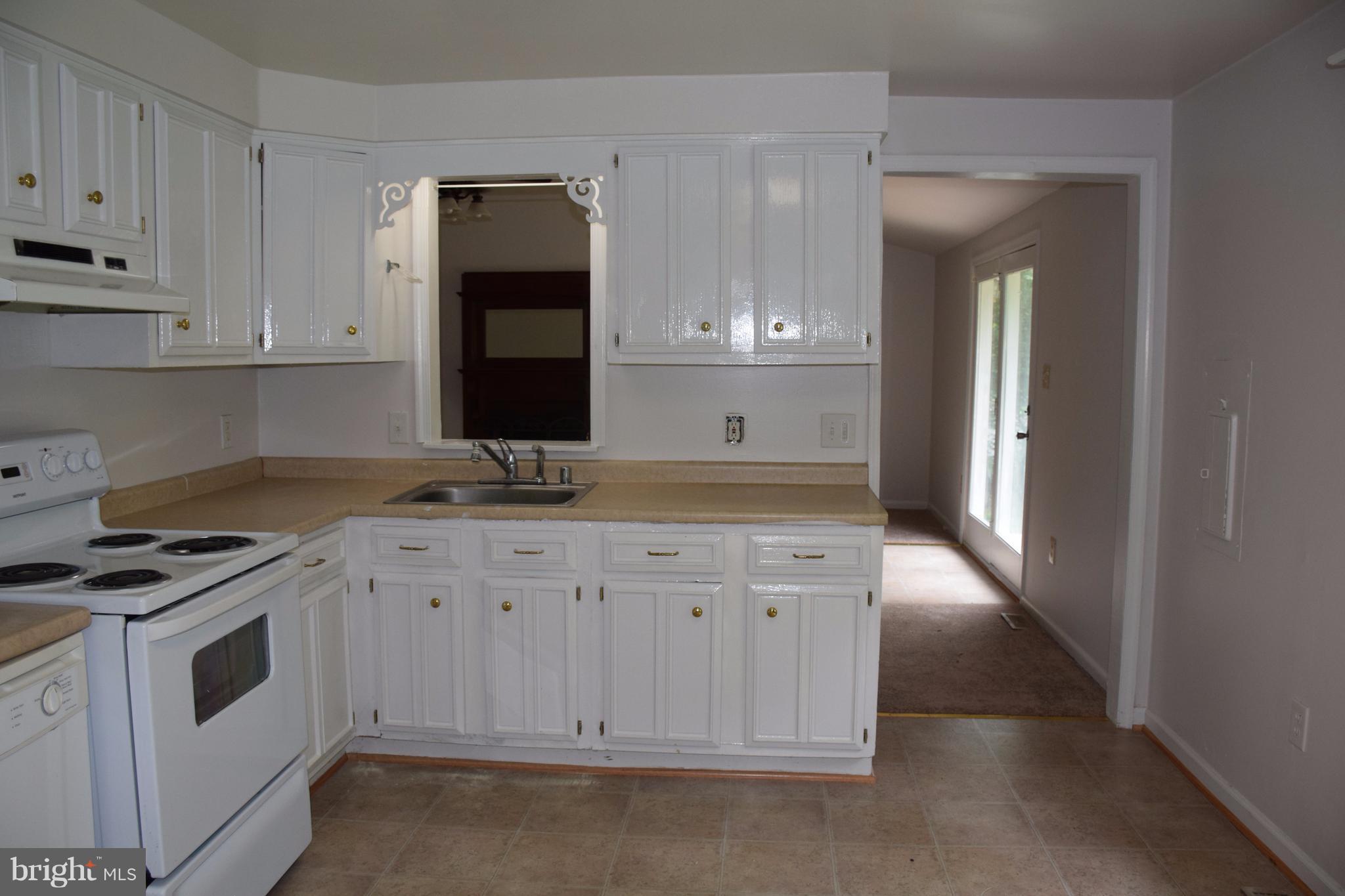 2471 Hallowing Point Road Prince Frederick, MD 20678 - Photo 14 of 30 a kitchen with granite countertop a sink stove and cabinets