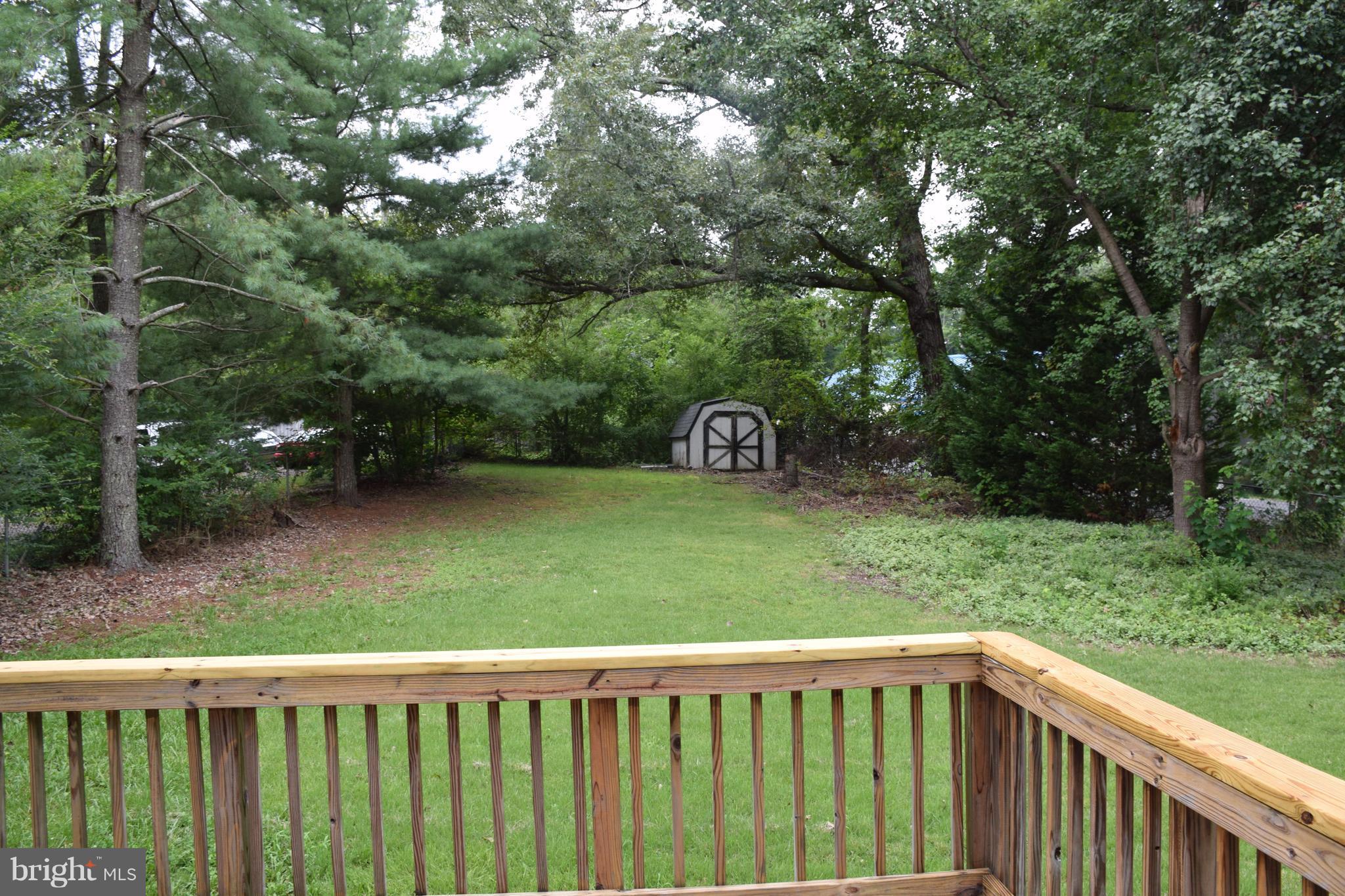 2471 Hallowing Point Road Prince Frederick, MD 20678 - Photo 27 of 30 a view of a backyard with a wooden fence