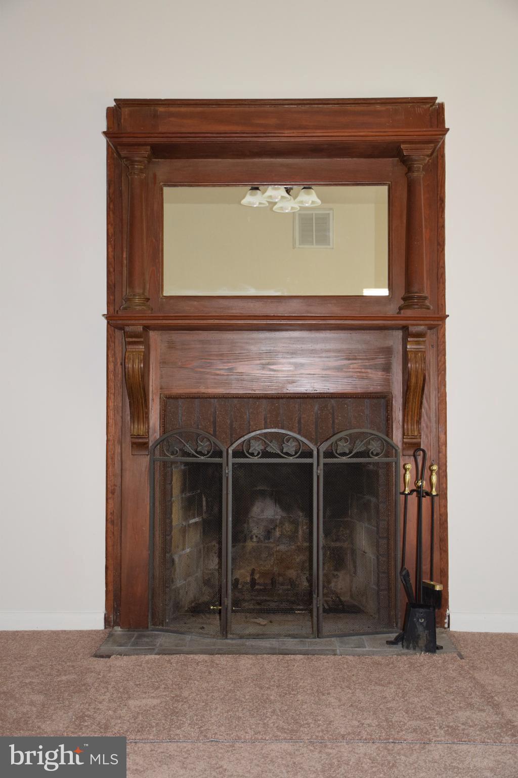 2471 Hallowing Point Road Prince Frederick, MD 20678 - Photo 4 of 30 a fireplace with a clock on it