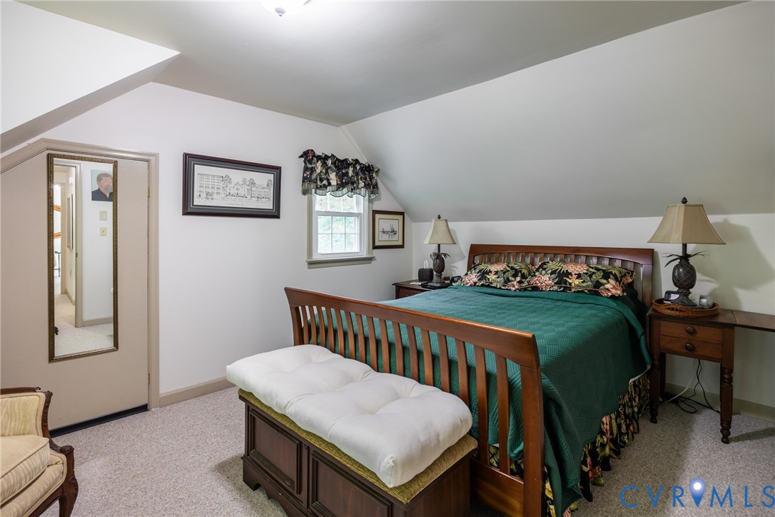 11766 Five Forks Road Farmville, VA 23901 - Photo 21 of 50 a bedroom with a bed next to a window with a lamp on table and chair