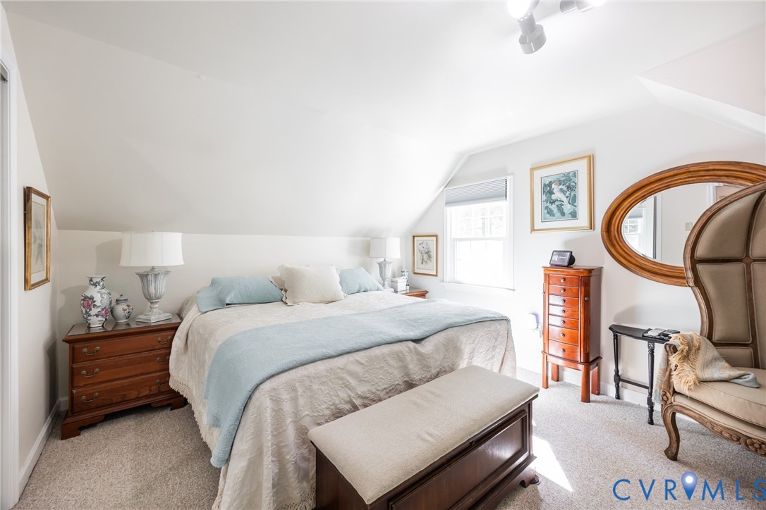 11766 Five Forks Road Farmville, VA 23901 - Photo 26 of 50 a bedroom with a bed a dresser and potted plants with the wooden floor