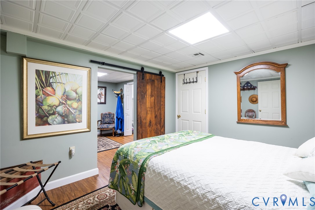 11766 Five Forks Road Farmville, VA 23901 - Photo 34 of 50 a bedroom with a bed and wooden floor