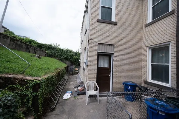 a view of backyard with outdoor seating and plants
