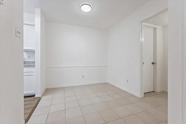 a view of a kitchen with a sink and a refrigerator