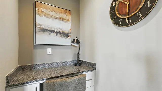 a living room with furniture kitchen view and a chandelier