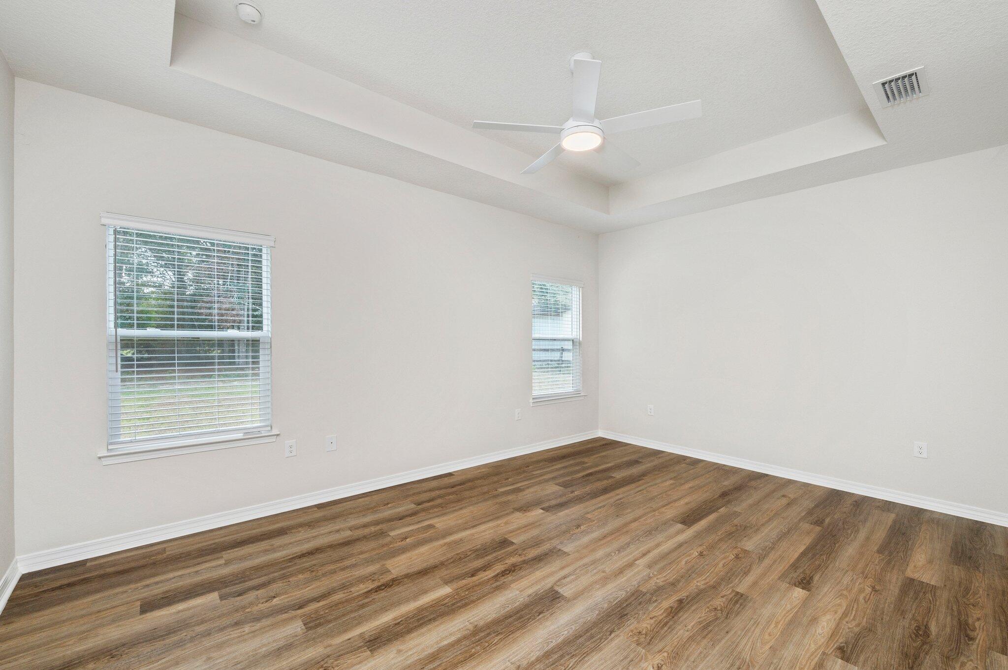 3156 Forrest Avenue Crestview, FL 32539 - Photo 21 of 44 an empty room with wooden floor and windows