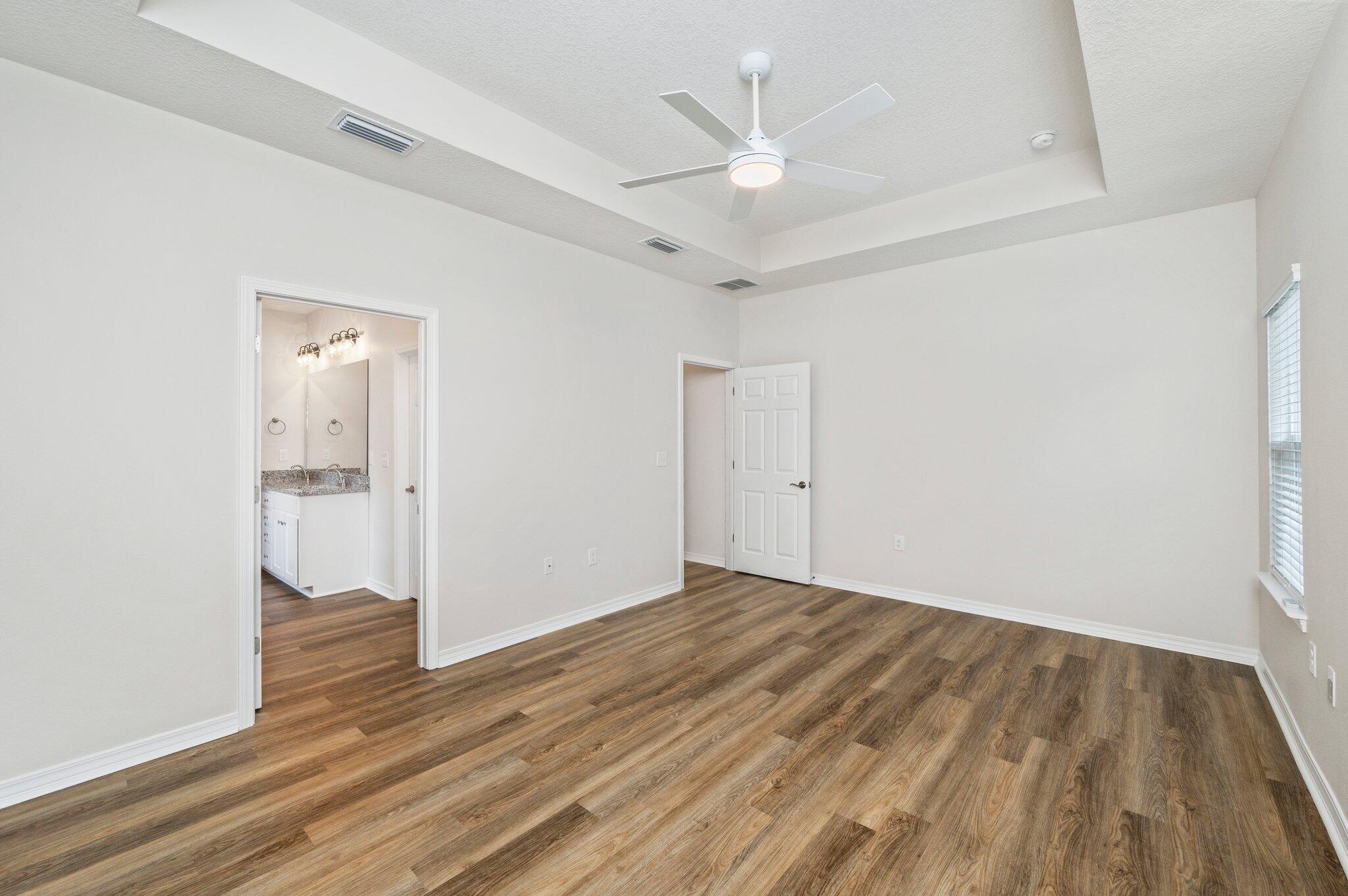 3156 Forrest Avenue Crestview, FL 32539 - Photo 23 of 44 an empty room with wooden floor and a ceiling fan