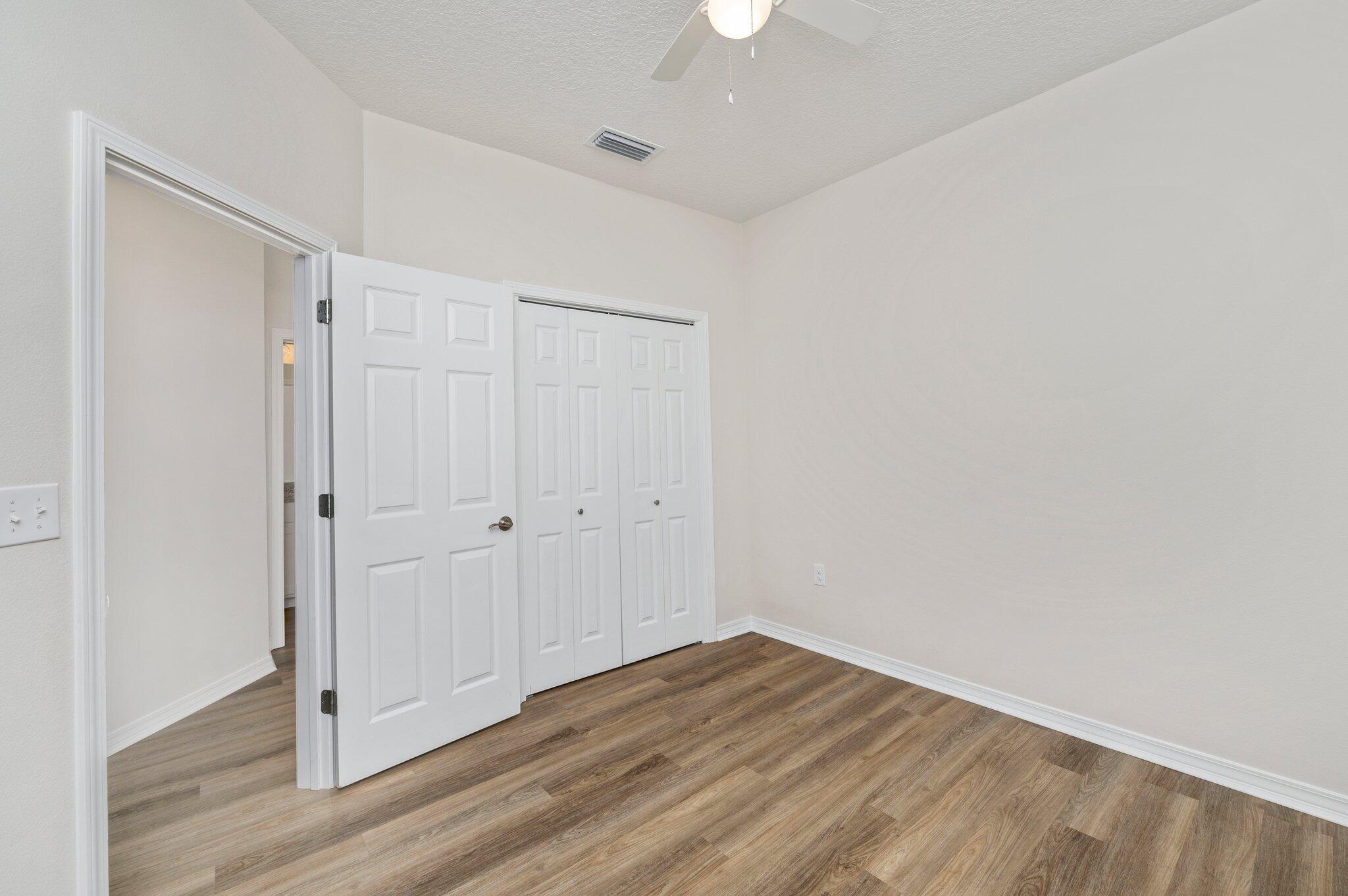 3156 Forrest Avenue Crestview, FL 32539 - Photo 31 of 44 a view of an empty room with wooden floor