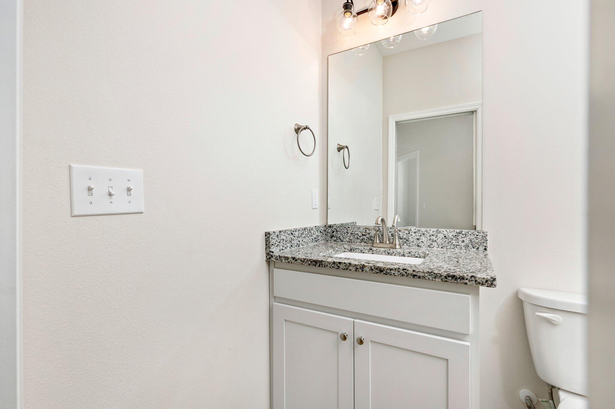 3156 Forrest Avenue Crestview, FL 32539 - Photo 36 of 44 a bathroom with a granite countertop sink and a mirror