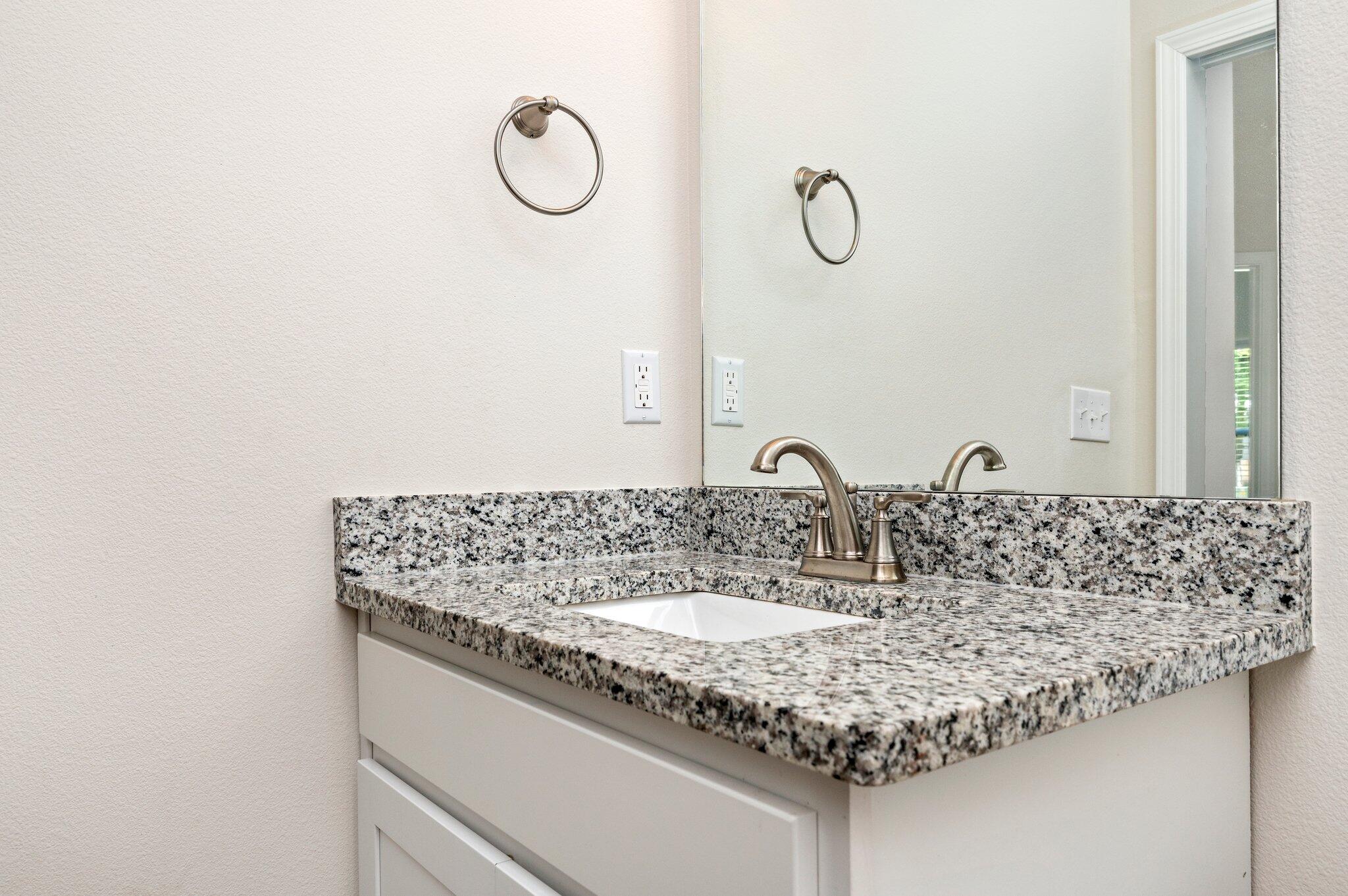 3156 Forrest Avenue Crestview, FL 32539 - Photo 38 of 44 a bathroom with a granite countertop sink and a mirror