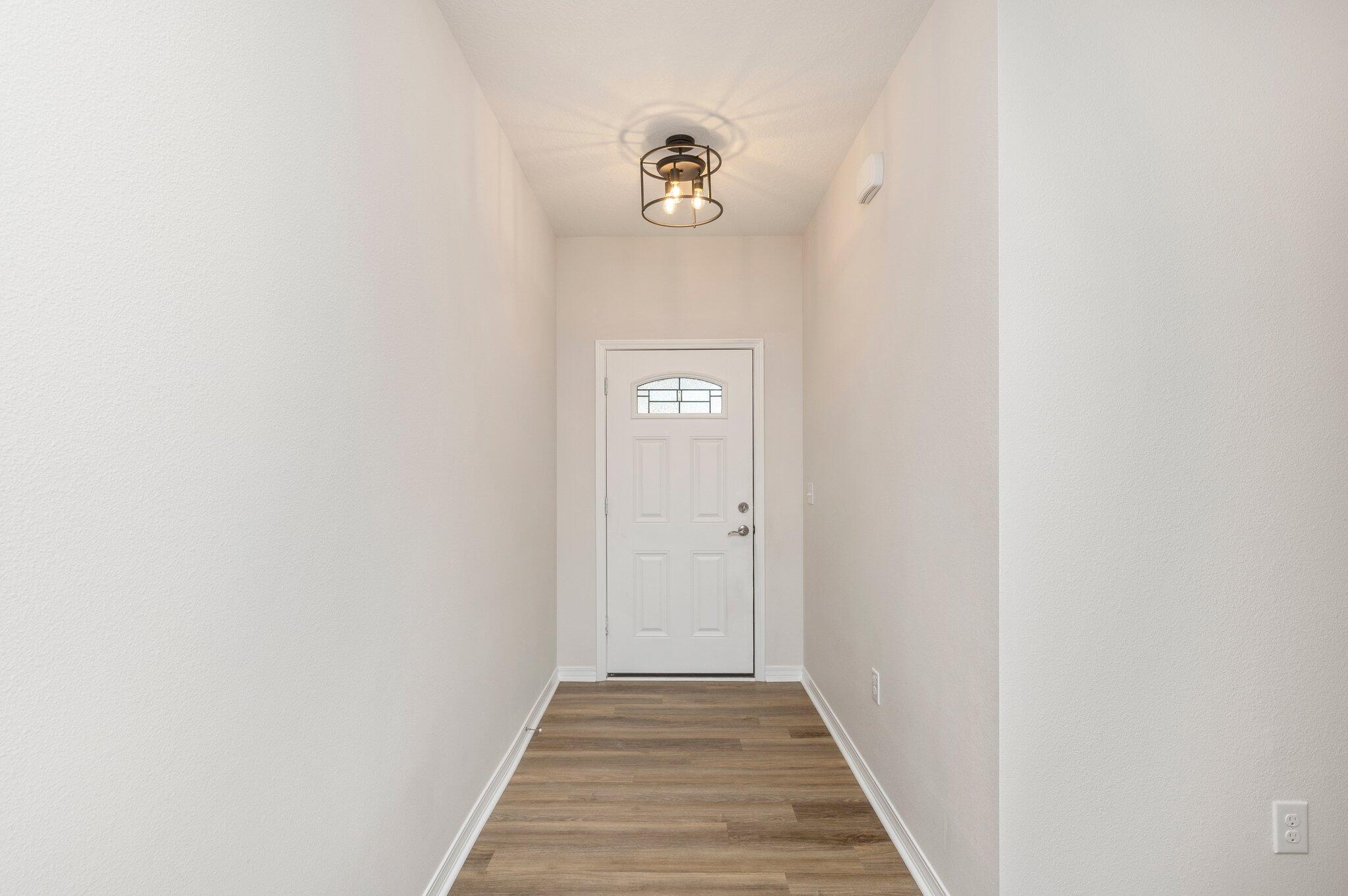 3156 Forrest Avenue Crestview, FL 32539 - Photo 5 of 44 a view of a hallway with wooden floor