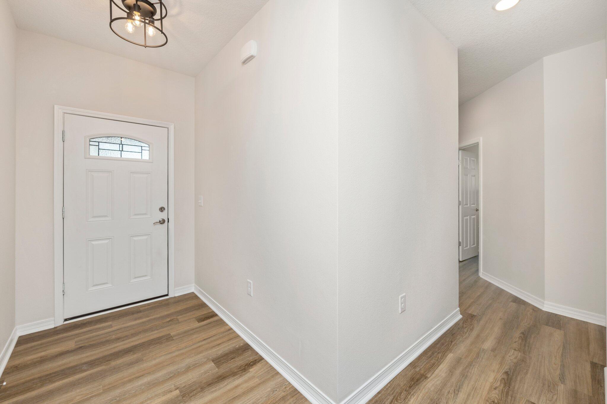3156 Forrest Avenue Crestview, FL 32539 - Photo 6 of 44 a view of a hallway with wooden floor