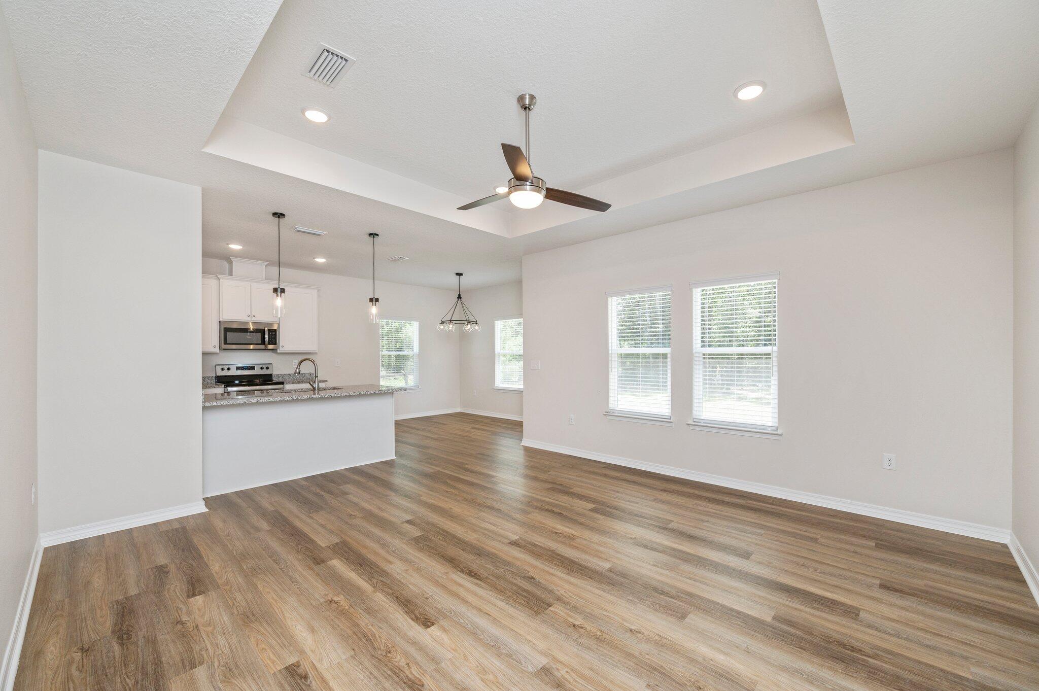 3156 Forrest Avenue Crestview, FL 32539 - Photo 7 of 44 a large kitchen with granite countertop a refrigerator and a stove top oven