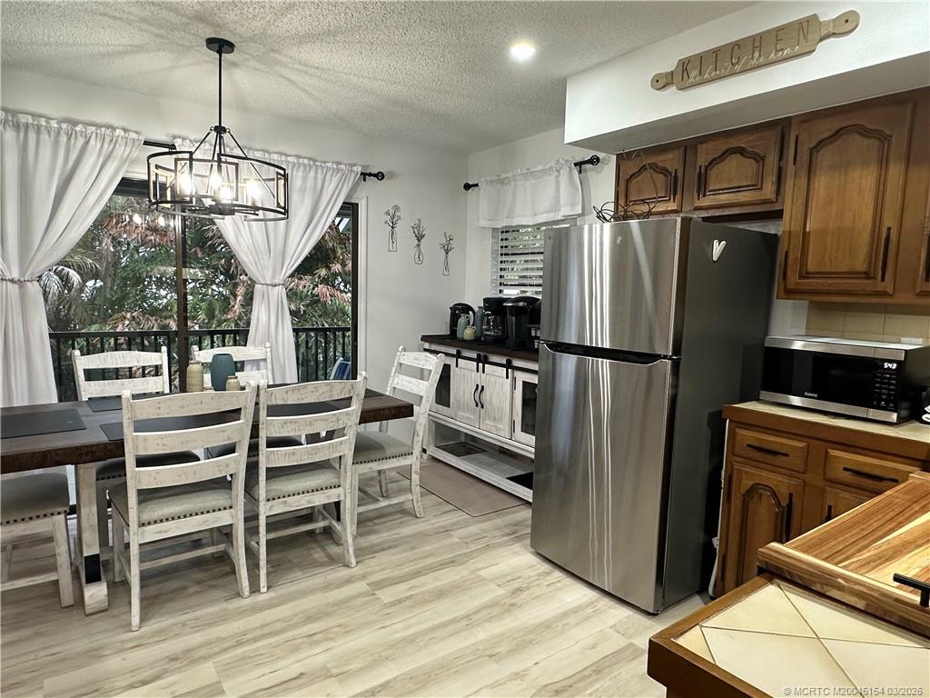 4095 Southeast Centerboard Lane, Unit 6B Stuart, FL 34997 - Photo 14 of 83 a kitchen with stainless steel appliances granite countertop a refrigerator and a stove top oven