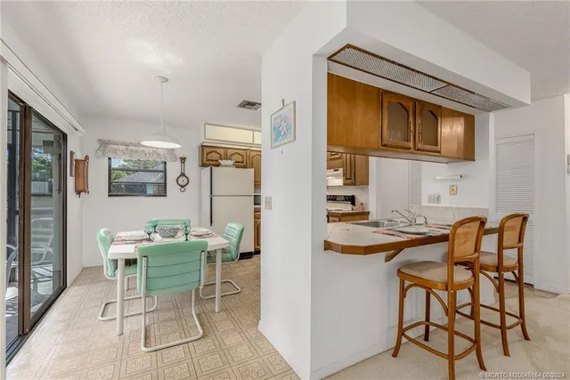 a kitchen with stainless steel appliances granite countertop a refrigerator and a stove