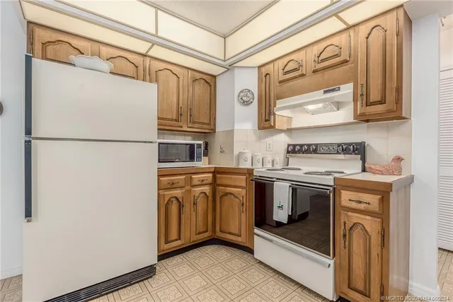 a spacious bedroom with a bed and a lamp