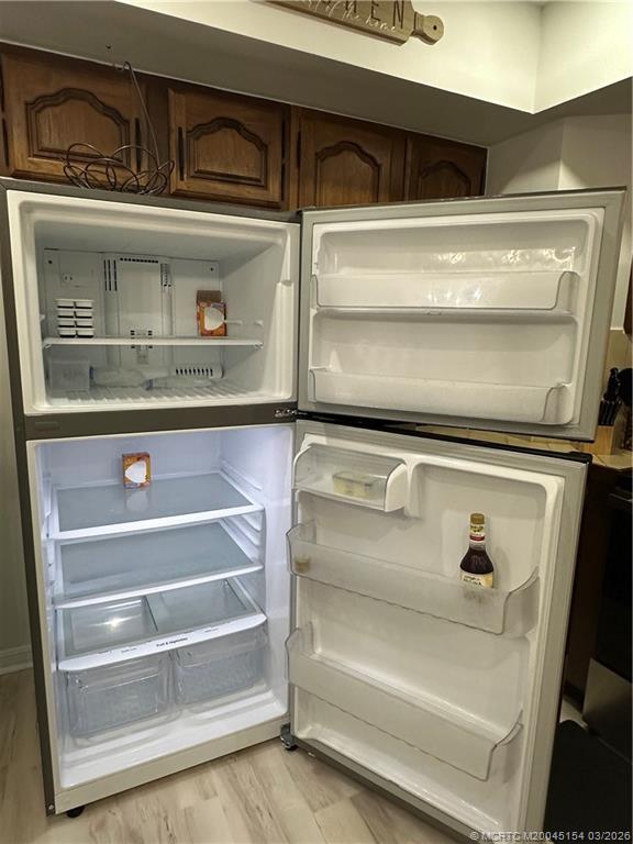 4095 Southeast Centerboard Lane, Unit 6B Stuart, FL 34997 - Photo 23 of 83 a view of a refrigerator with washing machine