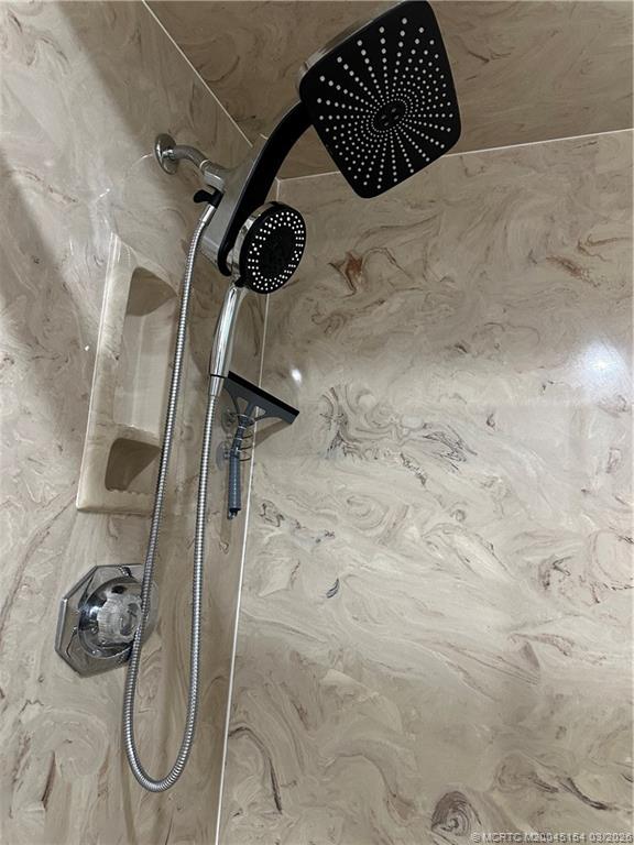 4095 Southeast Centerboard Lane, Unit 6B Stuart, FL 34997 - Photo 32 of 83 a bathroom with a shower