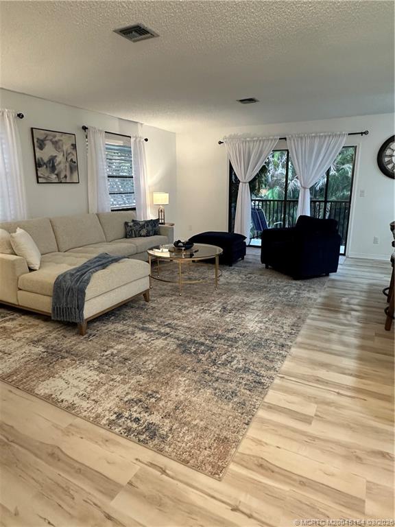 4095 Southeast Centerboard Lane, Unit 6B Stuart, FL 34997 - Photo 7 of 83 a living room with furniture flat screen tv and a rug